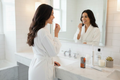 Dental floss woman white robe bathroom styled counter
